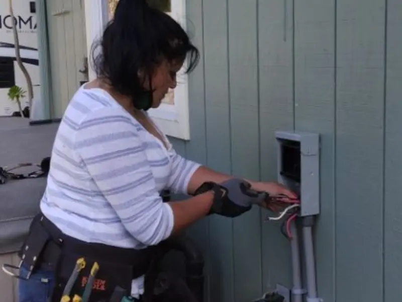 Licensed electrician wiring an exterior subpanel in Troutdale